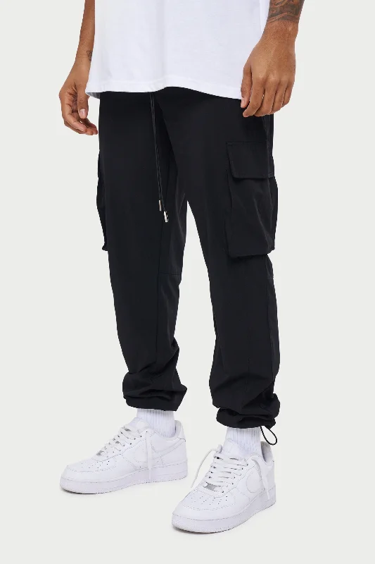 Men's cargo pants with reflective strips for enhanced visibility at nightCargo Pants with a Drawstring Ankle for a Custom and Adjustable FitTECHNICAL SMART CARGO PANTS - BLACK Men's cargo pants with reflective strips for enhanced visibility at nightCargo Pants with a Drawstring Ankle for a Custom and Adjustable FitTECHNICAL SMART CARGO PANTS - BLACK
